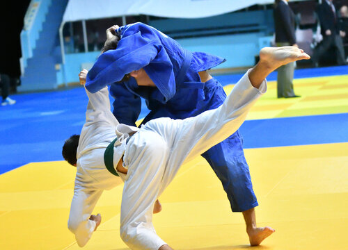 Two Boys judoka in kimono compete on the tatami 