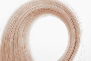 Beige curled strings on light background minimalistic wallpaper with place for text