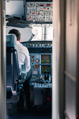 controls and buttons of an aircraft. Pilot in the cockpit making flight preparations. aircraft operating controls. cabin of an airplane. Flight captain sitting in the cockpit chair