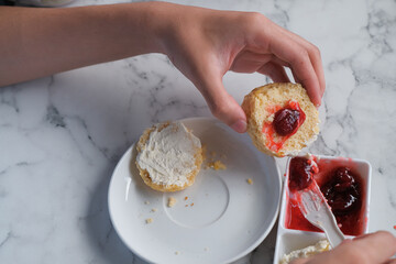 Scone with strawberry jam and clotted cream.