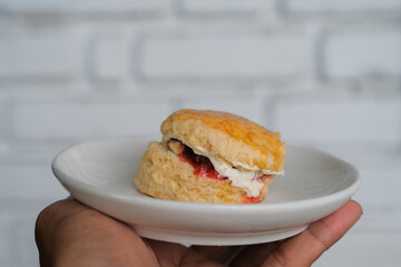 Scone with strawberry jam and clotted cream.