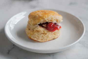 Scone with strawberry jam and clotted cream.