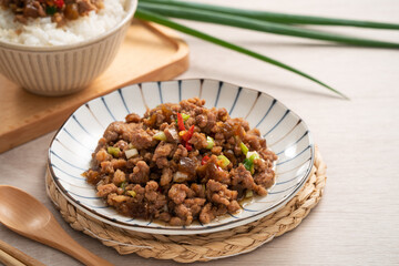 Taiwanese fried minced pork with pickled cucumber on rice named GUA ZI ROU FAN.