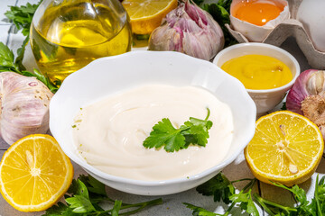 Homemade mayonnaise sauce. Bowl of mayonnaise with fresh ingredients top view copy space