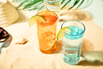 Summer alcoholic cocktails in colorful glasses on beach with white sand. Summer sea ocean vacation and travel concept