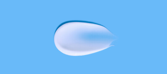 cosmetic smear cream texture on blue background	
