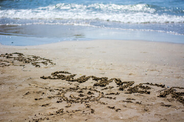 the sun and the inscription summer on the sand