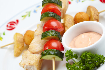 chicken kebab with sauce and herbs