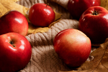 Fresh red ripe apples scattering on table surface
