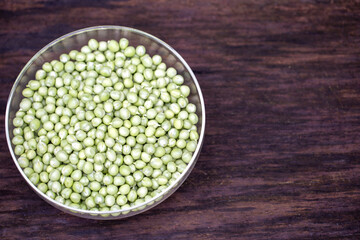 peeled peas in a bowl on wood with copy space. Healthy eating concept