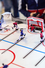 Blurred figure of a hockey player with a stick from a toy mini-hockey on a blurred background of a...