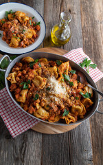 Italian pasta dish with tortellini, chick peas, pancetta, vegetable and tomato sauce