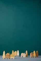 set of wooden house and tree decoration in village on grey floor and green background