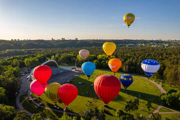 Aerial spring evening view of rising hot air balloons over Vingis Park in Vilnius, Lithuania