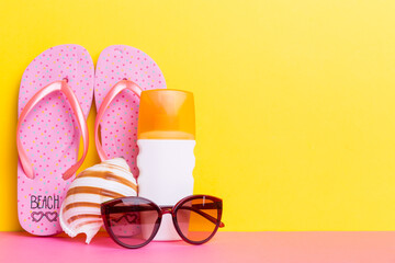 Beach accessories. Flip flops and starfish on colored background. Mock up with copy space