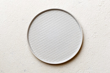 Top view of empty light plate on cement background. Empty space for your design