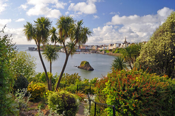 A picturesque view of the popular seaside resort of Tenby in South Wales showing the blue sea blue sky and fluffy white clouds  with the charming town in the background  