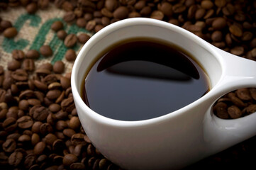 Cup of Coffee on Burlap with Dramatic Lighting