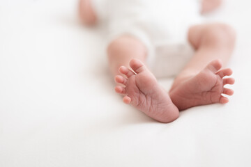 one week old cute newborn infant baby boy expressions tiny feet details  - obrazy, fototapety, plakaty