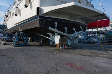 The lower part of the ship, a view of the propeller and rudder during maintenance in the dock.