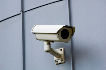 City monitoring system camera at building wall.