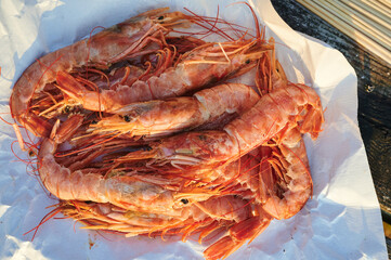 handful of prawns ready to barbecue on sunny day