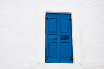 Obraz na płótnie Canvas Blue wooden window shutters of building facade exterior architectural detail of mediterranean house