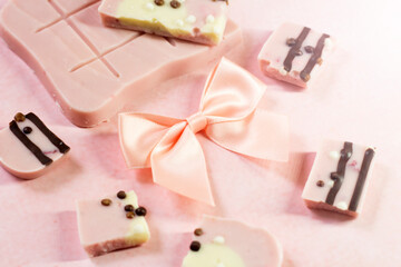 Pink chocolate with berry flavor and a satin bow, a delicious dessert