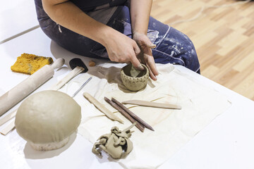 Handmade Workshop. Female Pottery Artist Making Ceramics On Table At Art Studio. Creative Hobby. Closeup View Of Woman Hands.