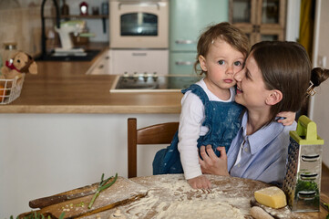 dad mom and their daughter cook pizza together in the kitchen. The concept of a happy family