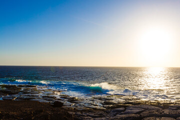 Evening scene on sea, stones, calm ocean