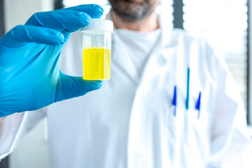 Scientist with a bottle of synthetic petrol