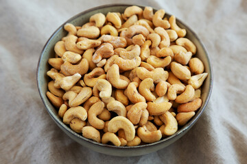 Homemade Roasted and Salted Cashews in a Bowl, side view. Close-up.