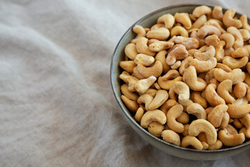 Homemade Roasted and Salted Cashews in a Bowl, side view. Copy space.