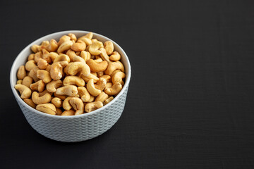 Homemade Roasted and Salted Cashews in a Bowl, side view. Copy space.