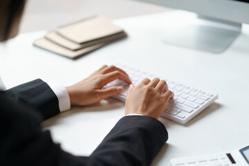 Business woman sitting using laptop computer with on the desk in the office.