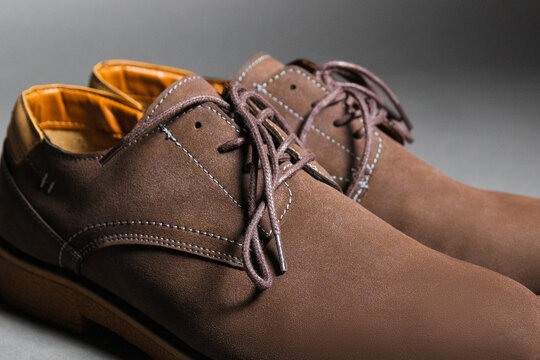 Men's brown leather lace-up shoes with orange leather interior