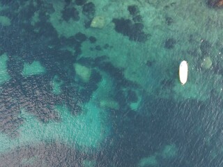 Obraz na płótnie Canvas Aerial view of Capri, an island located in the Tyrrhenian Sea off the Sorrento Peninsula, on the south side of the Gulf of Naples in the Campania region of Italy. Drone view of Faraglioni di Capri.