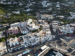 Fototapeta premium Aerial view of Marina Grande in Capri, an island located in the Tyrrhenian Sea off the Sorrento Peninsula, on the south side of the Gulf of Naples in the Campania region of Italy. Drone view of Capri.