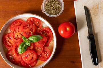 Tomato salad with tarragone and basil in red wine vinegar