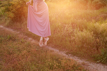 legs of a woman in pointe shoes in nature close-up. Banner © BartLoveyou
