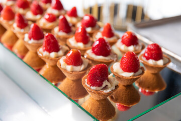 Mini Strawberry Fruit appetizing Tarts. Pastry cupcake dessert with strawberry fruits and cream