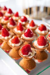 Mini Strawberry Fruit appetizing Tarts. Pastry cupcake dessert with strawberry fruits and cream