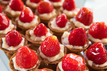 Mini Strawberry Fruit appetizing Tarts. Pastry cupcake dessert with strawberry fruits and cream