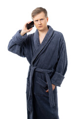 portrait of a man in a gray terry bathrobe. a man talking on the phone. communication with loved ones in the distance. quarantine. isolated.