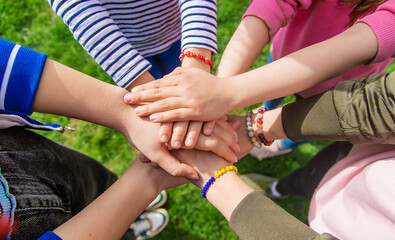 People put their hands together. Selective focus.