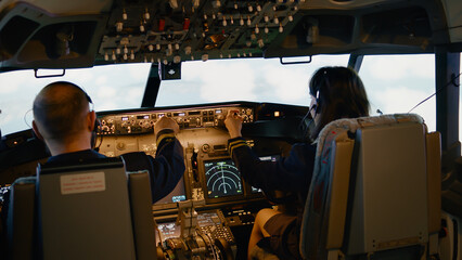 Team of aviators throttling power engine and fixing altitude level, preparing to takeoff and fly...