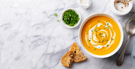 Pumpkin traditional soup with creamy silky texture. Marble background. Copy space. Top view. - 506806446