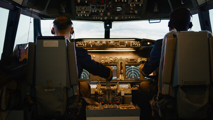 Captain and copilot throttling engine handle to fly airplane, taking off with international airline...