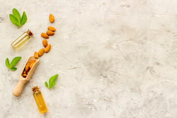 Almond oil and group of almond nuts with leaves
